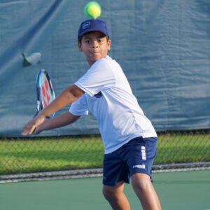 NMBA junior tennis player hitting forehand North Miami Beach Academy high-performance training
