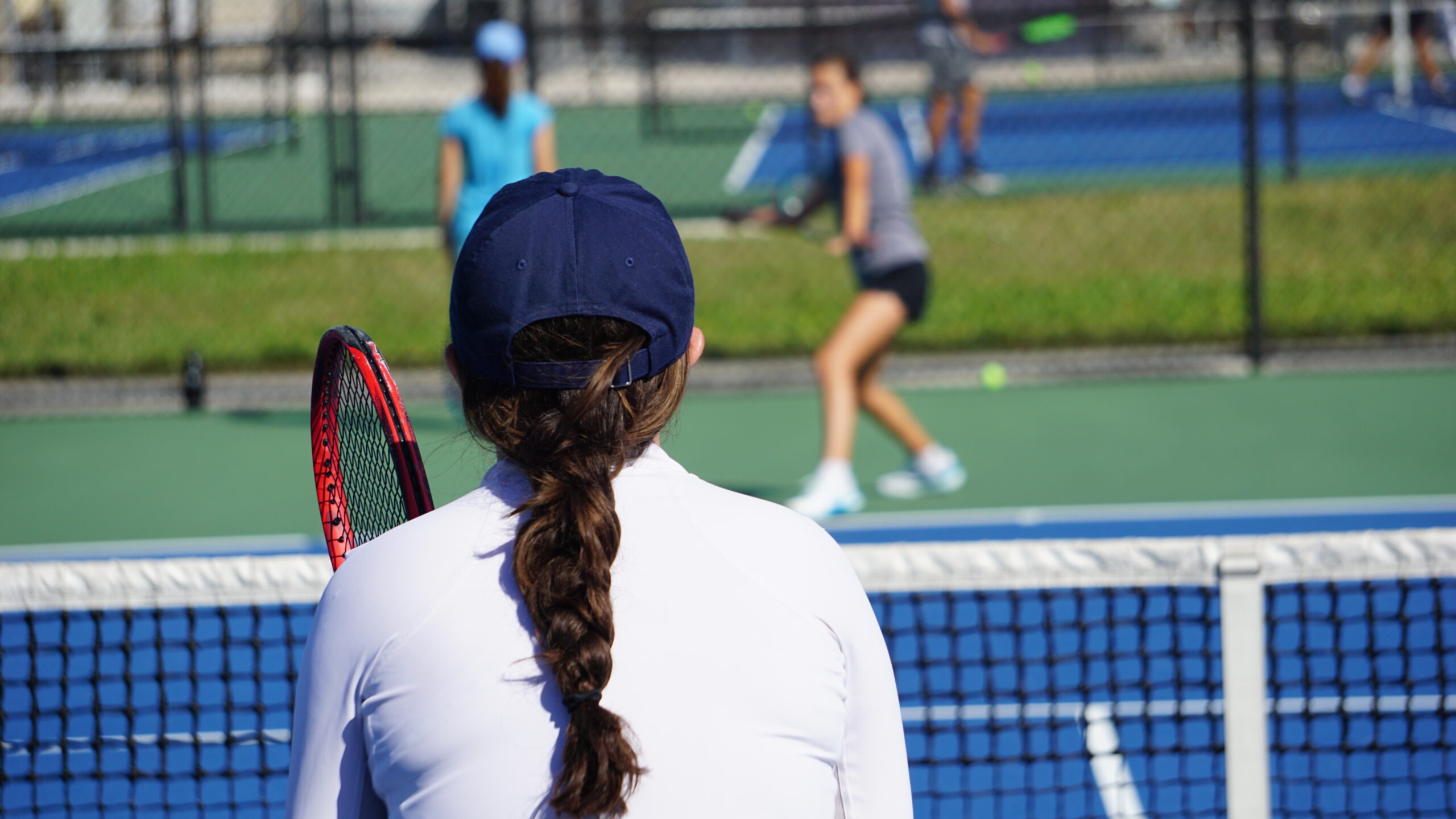 NMBA junior female tennis coach with braid North Miami Beach Academy training