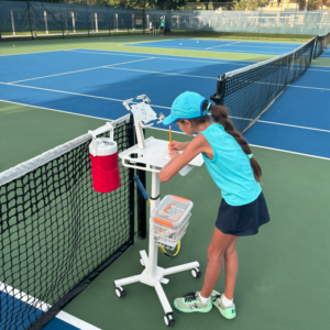NMBA junior tennis player training at net North Miami Beach Academy
