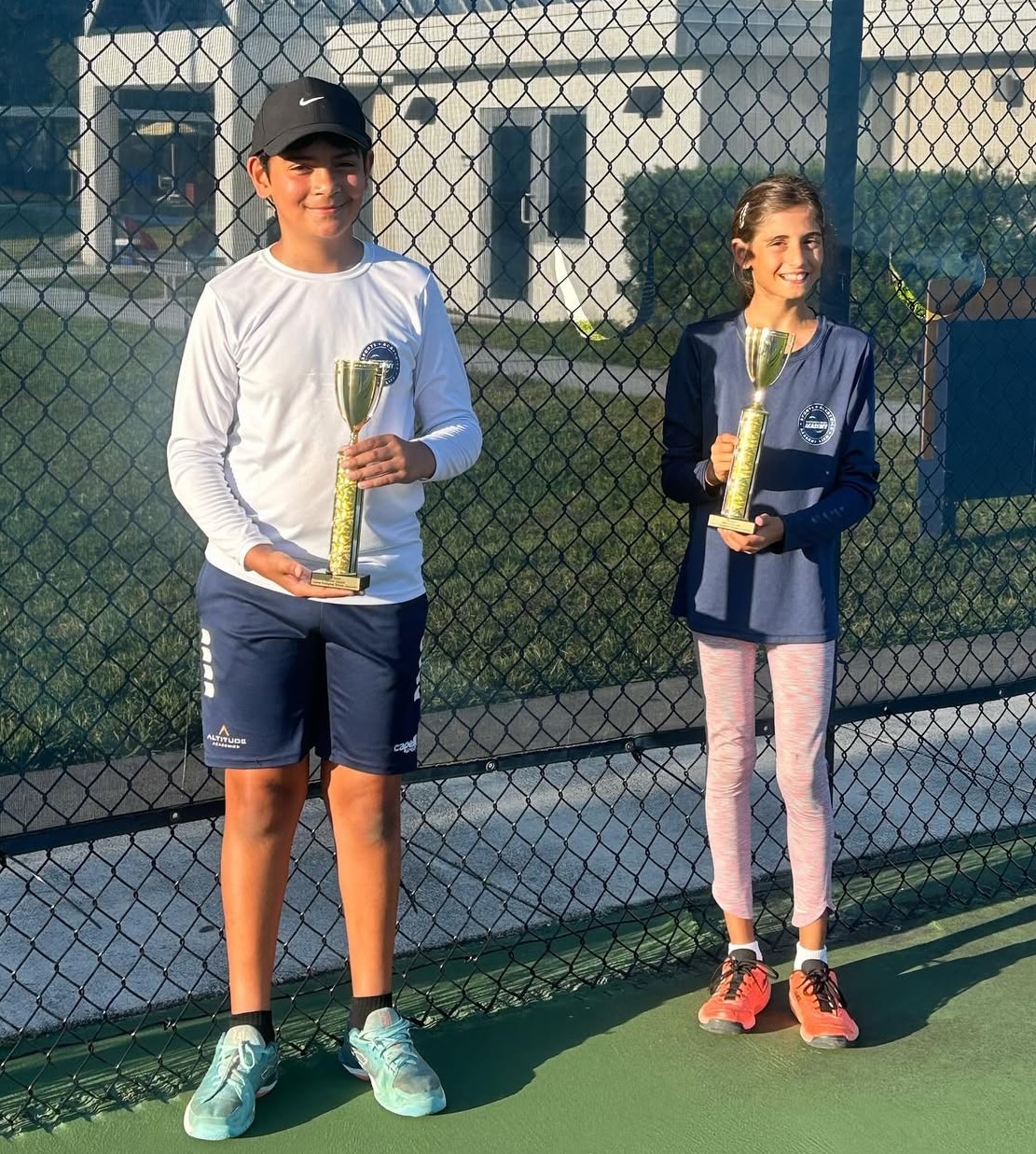 Diego and Ayana celebrating doubles championship — NMBA junior tennis champions