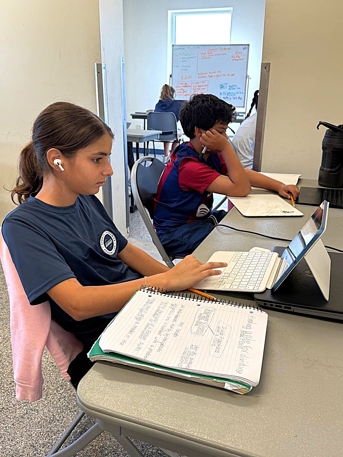NMBA teacher providing one-on-one academic coaching to a student-athlete at North Miami Beach Academy