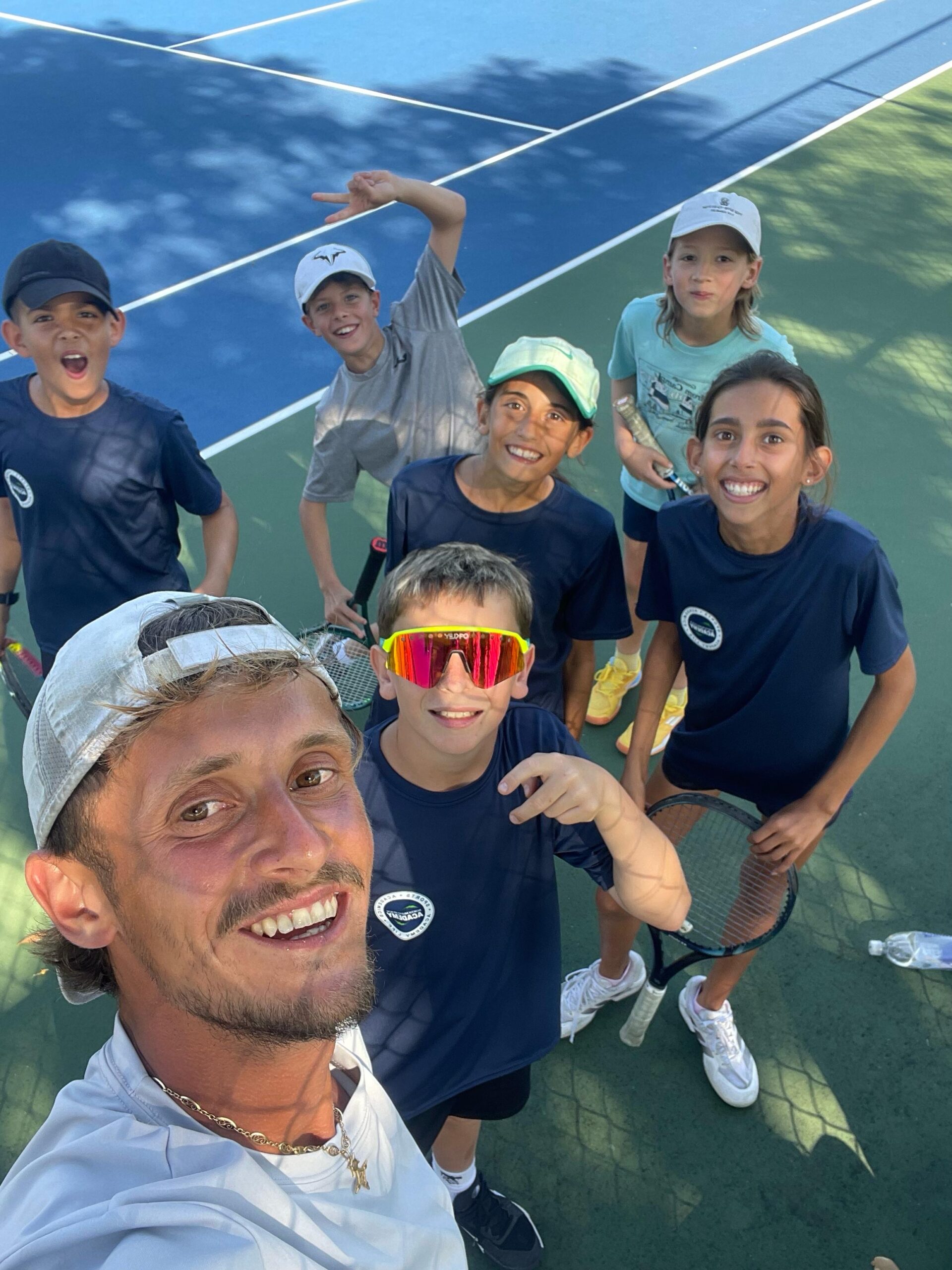 NMBA student athletes smiling North Miami Beach Academy tennis program